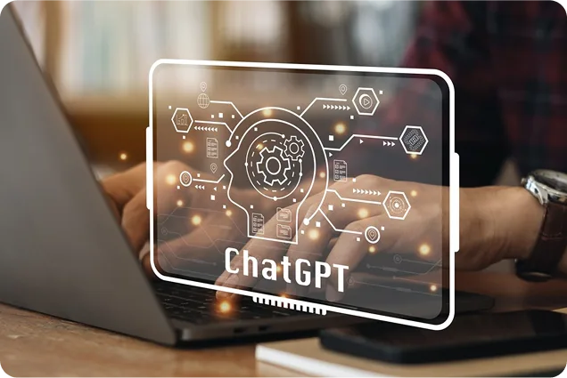 Person typing on laptop with a digital overlay of a human head and gears labeled ChatGPT.